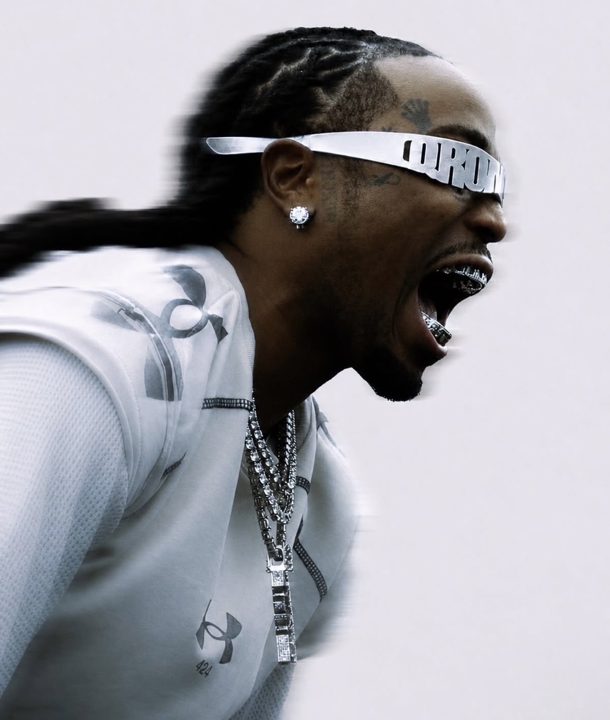 Quavo in profile wearing the handmade polished aluminum QRÖMELIFE glasses
